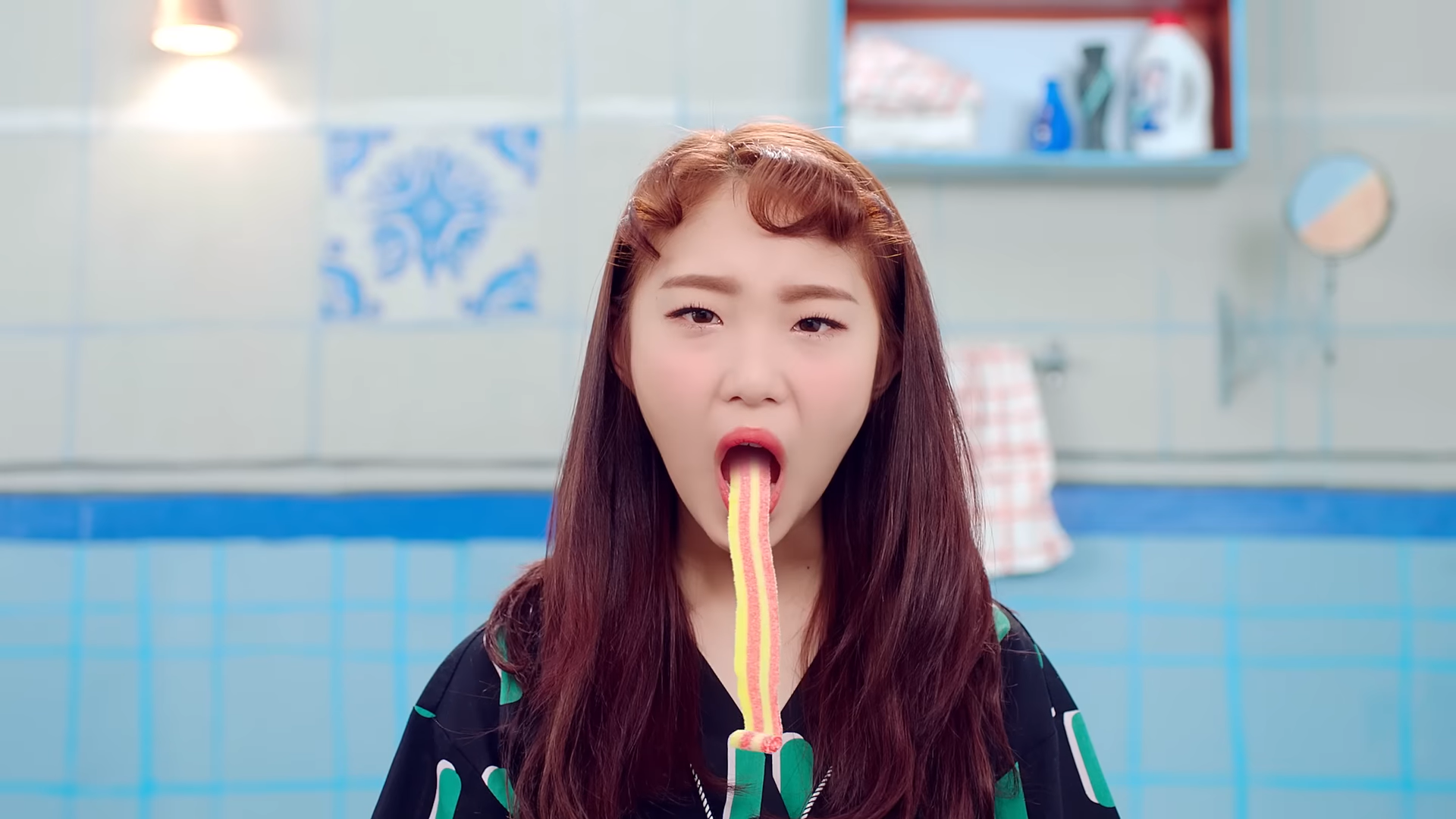 Yeojin sticking out a tongue made of candy.